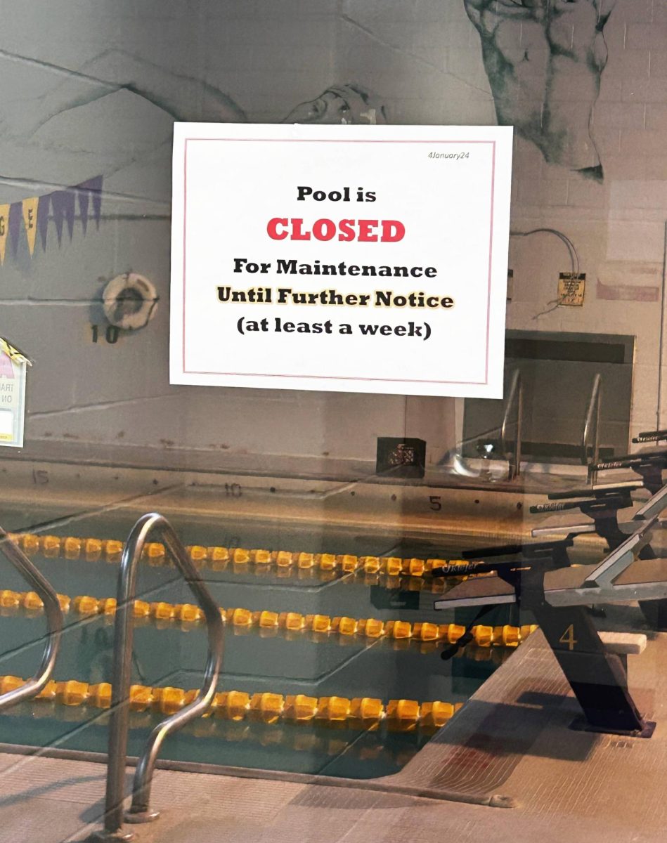 The Knox College pool pictured behind a window that contains a note reading: Pool is CLOSED For Maintenance Until Further Notice (at least a week).