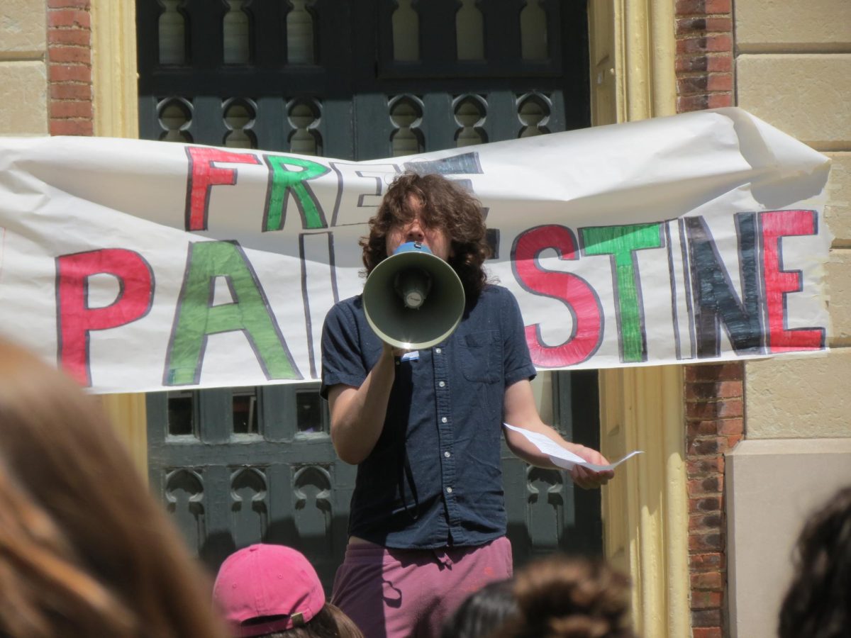 Winter Goodner speaking in front of the Free Palestine poster hung on Old Mains South Lawn steps. 