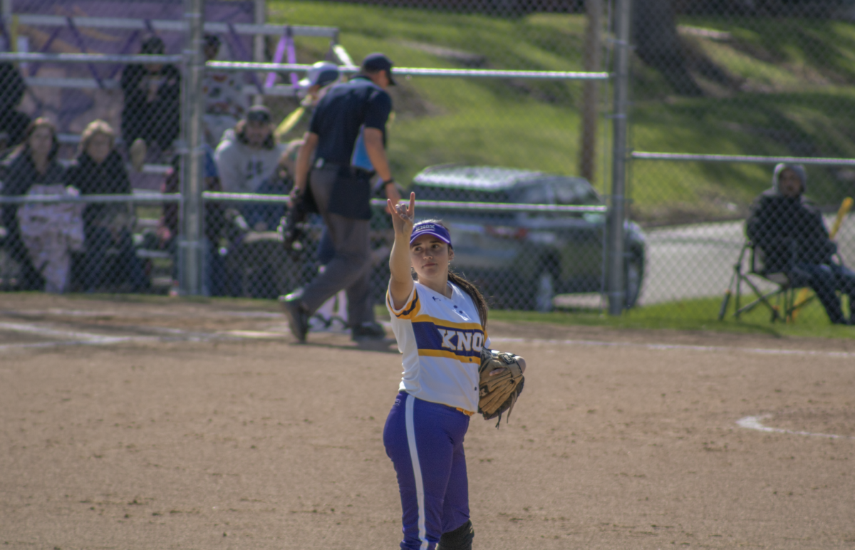 Carpenter signaling two outs toward the outfield during her fifth-year season